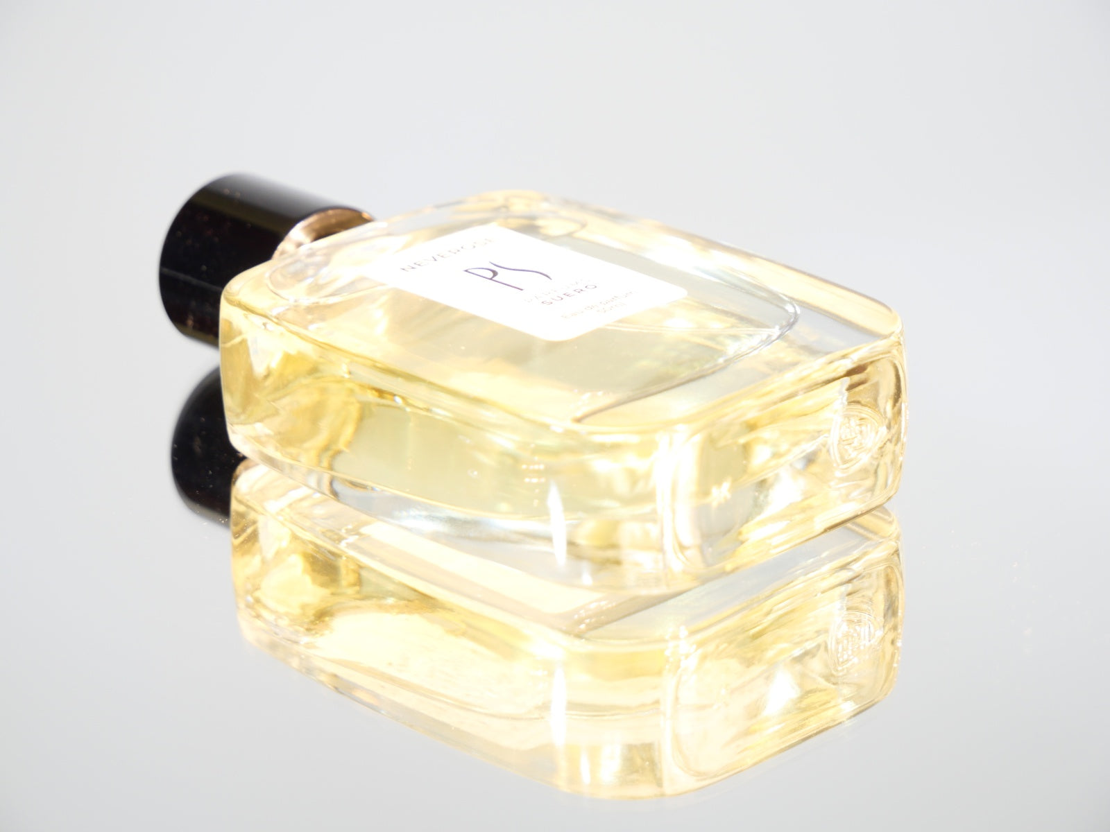 un flacon de parfum de la marque PARFUMS SUERO couché  sur un miroir 